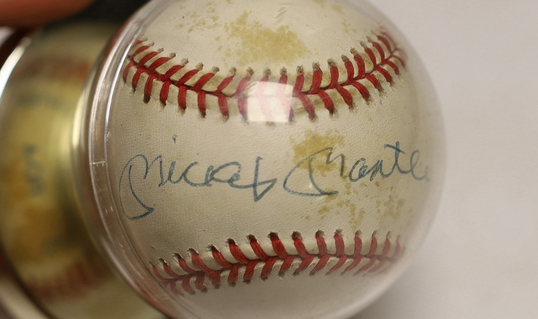 A Rawlings Costa Rica baseball autographed by Mickey Mantler, housed in a display case
